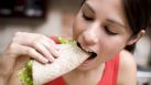 Woman eating a taco By: Aldo Murillo 
 Mexican food