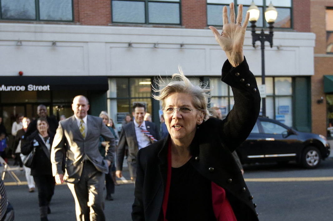 U.S. Sen Elizabeth Warren, D-Mass., center, waves as she arrives at a campaign event on Nov. 3, 2014, in Lynn, Mass. 