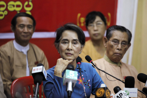 Myanmar's pro-democracy leader Suu Kyi listens as reporter asks her a question during a news conference in Yangon