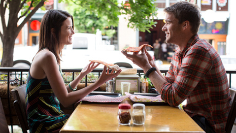 RedEye: Man and woman eating pizza at restaurant