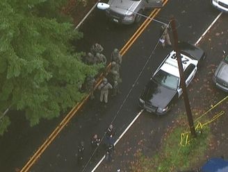 SWAT officers gather Oct. 31, 2014, at the scene in Vancouver, Wash., where police mistakely shot a man who had called 911 to report seeing a shooting suspect.