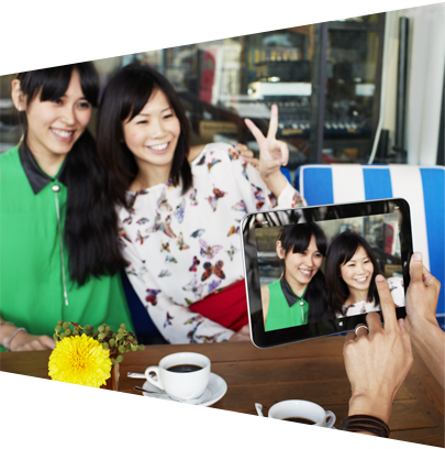 Two women taking photo with tablet