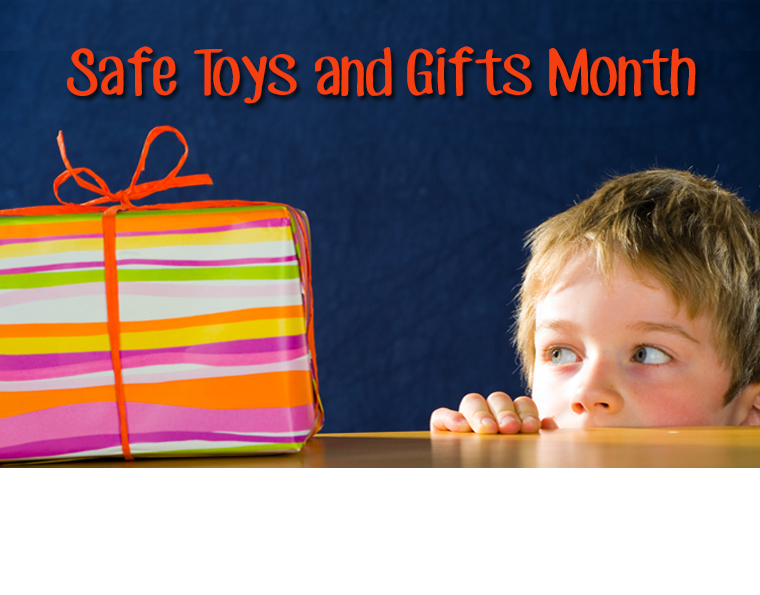 A young boy looks at a gift. The text says, "Safe Toys and Gifts Month"