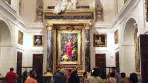 Tourists take photos and listen to an audio tour in front of El Greco's 'The Disrobing of Christ' inside Toledo's cathedral.