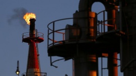 A flame shoots out of a chimney at a petro-industrial factory in Kawasaki near Tokyo December 18, 2014. REUTERS/Thomas Peter 