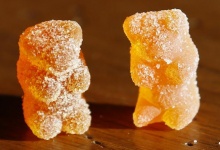 A marijuana-infused sour gummy bear candy (L) is shown next to a regular one at right in a photo illustration in Golden, Colorado October 17, 2014. REUTERS/Rick Wilking