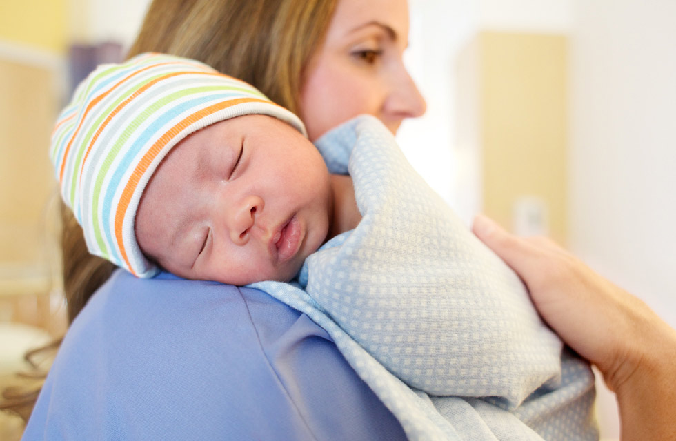 Nurse cuddling a newborn