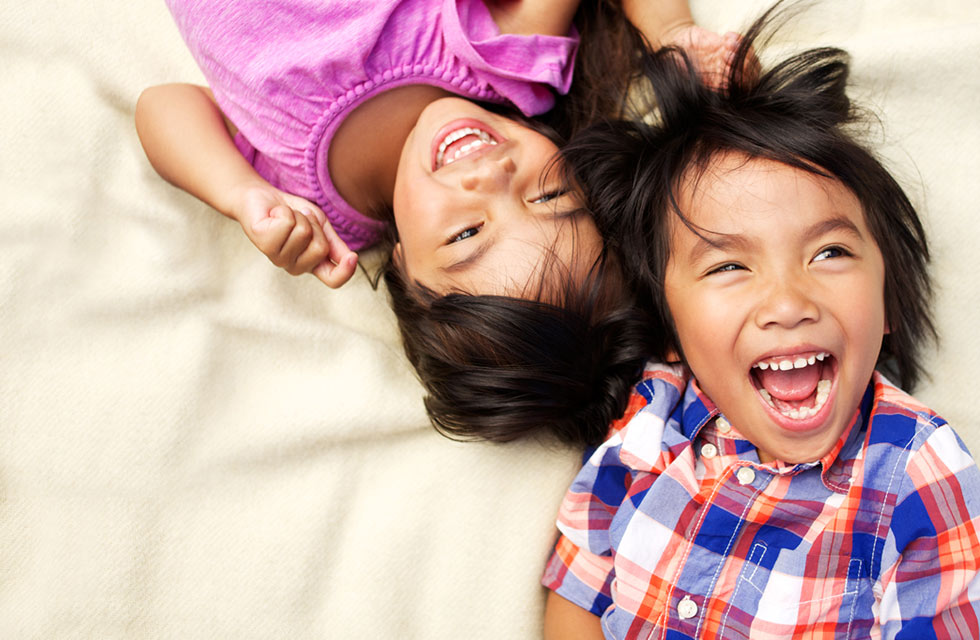 Brother and sister laughing