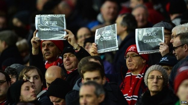 Manchester United fans hold up signs during a match against Southampton at Old Trafford 