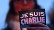 A woman holds a 'Je suis Charlie' sign