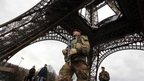 A French soldier patrols near the Eiffel Tower