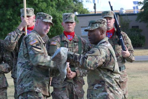 Lt. Col. Curran Chidester (left) and Command Sgt. Maj. Donnell Younger (right) case the battalion colors.