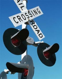 Close up shot of railroad crossing lights at an intersection.