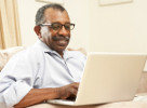 smiling man working on laptop
