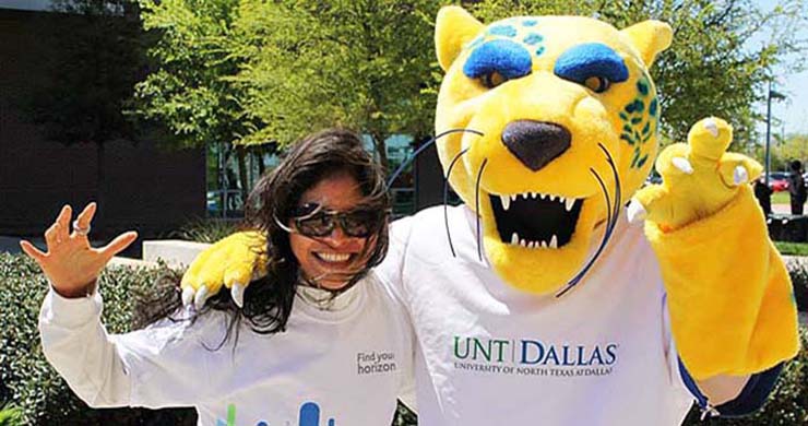 Woman with Jaguar mascot at UNT Dallas.