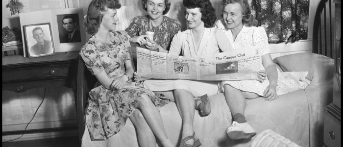 Female students read an issue of The Campus Chat in their dorm room, 1942.