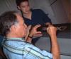 Guest composer John Chowning signing Cindy McTee's DX-7 while composition student Daniel Chan looks on (September 2005).