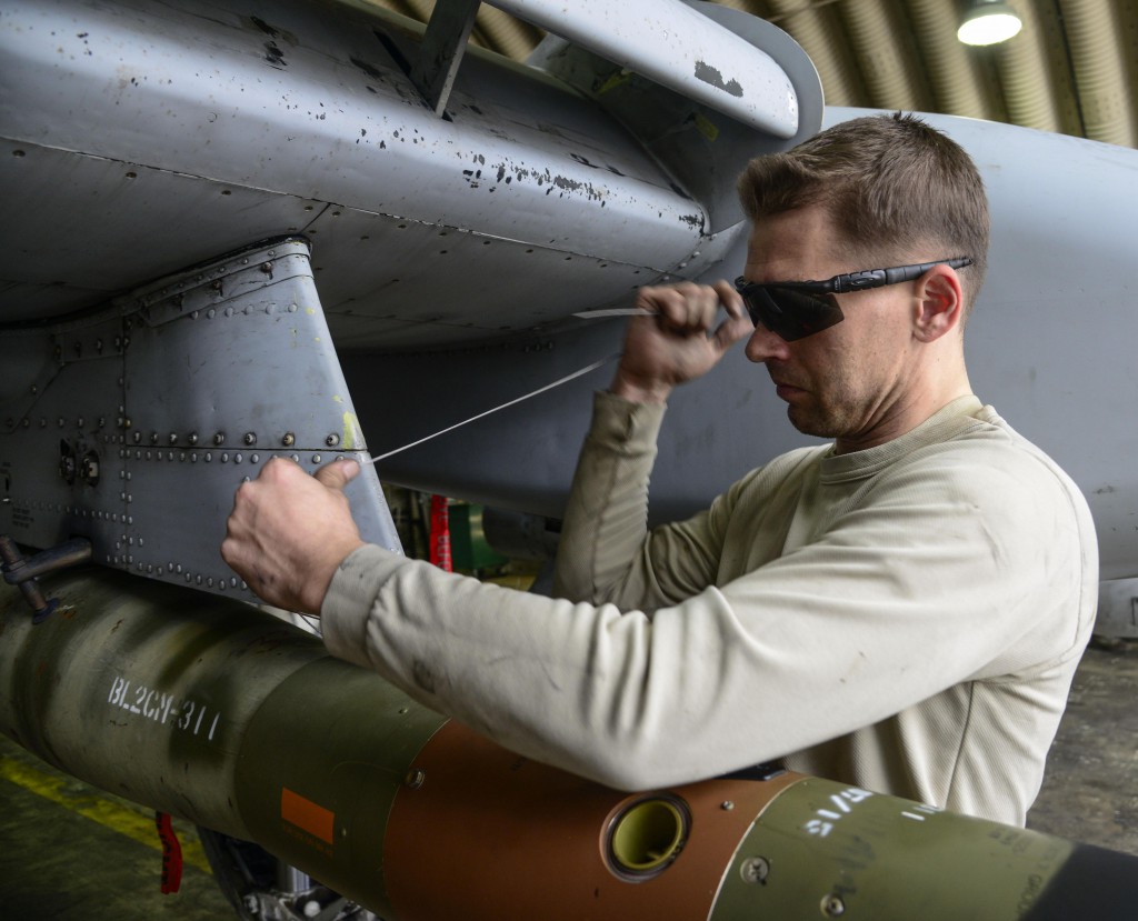 Staff Sgt. Christopher Uecker, 25th Aircraft Maintenance Unit weapons load crew team chief, tightens arming wire on an A-10 Thunderbolt II during the Vigilant Ace 16 exercise on Osan Air Base, Republic of Korea, Nov. 1, 2015. The arming wire holds the guided bomb unit in place until proper aerial release. (U.S. Air Force photo by Senior Airman Kristin High/Released)