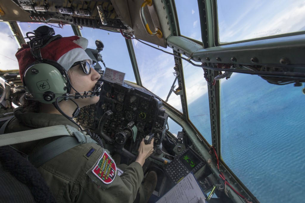 First Lt. Sydney Croxton, 36th Airlift Squadron C-130 pilot, flies over Republic of Palau, Dec. 11, 2015, during Operation Christmas Drop. This year marks the 64th year of Operation Christmas Drop, which began in 1952, and is the first trilateral execution of the event with support from Japan Air Self-Defense Force and Royal Australian Air Force C-130s. (U.S. Air Force photo by Osakabe Yasuo/Released)