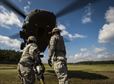 Airmen from the 321st Contingency Response Wing from Joint Base McGuire-Dix-Lakehurst, N.J., try to attach a sling load to a Mississippi Army National Guard medical evacuation UH-60 Black Hawk at Camp Shelby Joint Forces Training Center, Miss., during exercise Turbo Distribution Oct. 29, 2015. The U.S. Transportation Command exercise tested the Joint Task Force-Port Opening&#39;s ability to deliver and distribute cargo during humanitarian relief operations. (U.S. Air Force photo/Staff Sgt. Marianique Santos)