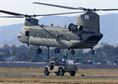 Airmen from the 60th Aerial Port Squadron and members of the Army National Guard&#39;s 49th Police Brigade practice loading and sling loading vehicles on a CH-47 Chinook cargo helicopter Oct. 14, 2015, at Travis Air Force Base, Calif. The units also practiced nighttime operations in total darkness with the aid of night vision goggles. (U.S. Air Force photo/T.C. Perkins Jr.) 