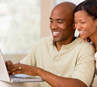 Couple logging onto laptop for secure services