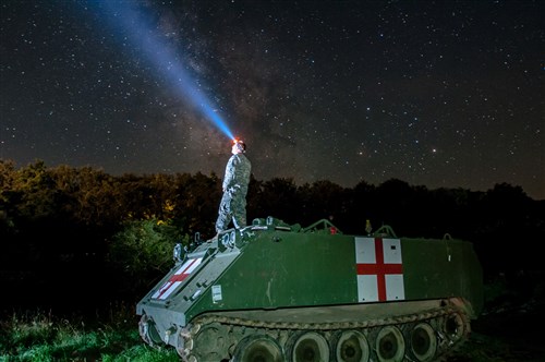 Staff Sgt. Brad Foster, a combat medic with Headquarters and Headquarters Company, 3rd Battalion, 116th Cavalry Brigade Combat Team out of Pendleton, Oregon, watches the night sky on top of an M113 Medical Evacuation Vehicle during Exercise Saber Guardian 16 at the Romanian Land Forces Combat Training Center in Cincu, Romania. Saber Guardian is a multinational military exercise involving approximately 2,800 military personnel from ten nations including Armenia, Azerbaijan, Bulgaria, Canada, Georgia, Moldova, Poland, Romania, Ukraine and the U.S. (U.S. Army photo by Spc. Timothy Jackson, 115th Mobile Public Affairs Detachment, Oregon Army National Guard).