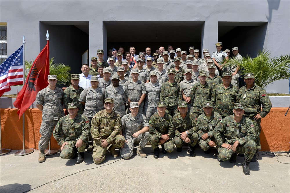 Distinguished visitors, U.S. Air Force, Army and Navy and Albanian Army land forces military leaders pose for a group photo after an inauguration ceremony marking the completion of renovation of the 12 year school in Mjede, Albania on July 15, 2016. The partial renovation of the school was made possible by the European Commands’ Humanitarian Civic Assistance (HCA) program of the United States Department of Defense.  (U.S. Air National Guard photo by Master Sgt. Andrew J. Moseley/Released)