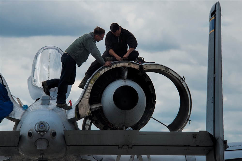 U.S. Air Force crew chiefs from the 354th Expeditionary Fighter Squadron perform maintenance on a U.S. Air Force A-10 Thunderbolt II attack aircraft engine during a theater security package deployment to Lask Air Base, Poland, July 9, 2015. The U.S. and Polish air forces will conduct training aimed to strengthen interoperability and demonstrate the countries' shared commitment to the security and stability of Europe. (U.S. Air Force photo by Staff Sgt. Christopher Ruano/Released)