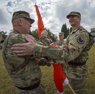 U.S. Army Reserve Maj. Gen. David J. Conboy, USAR deputy commanding general, hands the command flag to Brig. Gen. (Promotable) Peter A. Bosse, incoming commander of the 335th Signal Command (Theater) as Brig. Gen. Christopher R Kemp, outgoing commander, looks on during a change of command ceremony at Fort McPherson, Ga., Oct. 15, 2016. (U.S. Army photo by Staff Sgt. Ken Scar)