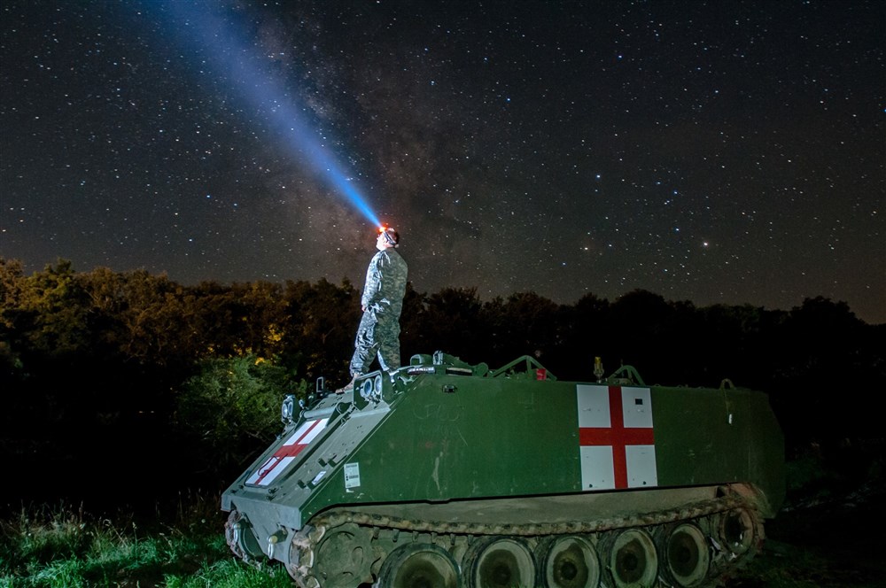 Staff Sgt. Brad Foster, a combat medic with Headquarters and Headquarters Company, 3rd Battalion, 116th Cavalry Brigade Combat Team out of Pendleton, Oregon, watches the night sky on top of an M113 Medical Evacuation Vehicle during Exercise Saber Guardian 16 at the Romanian Land Forces Combat Training Center in Cincu, Romania. Saber Guardian is a multinational military exercise involving approximately 2,800 military personnel from ten nations including Armenia, Azerbaijan, Bulgaria, Canada, Georgia, Moldova, Poland, Romania, Ukraine and the U.S. (U.S. Army photo by Spc. Timothy Jackson, 115th Mobile Public Affairs Detachment, Oregon Army National Guard).