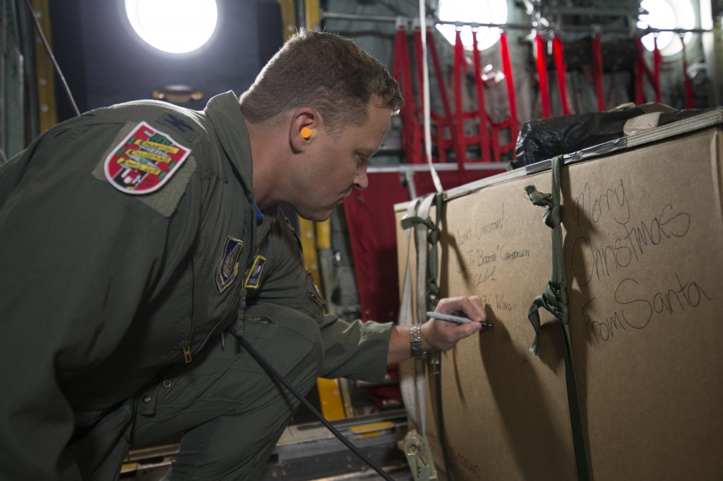 Col. TY Chamberlain, 36th Wing vice- commander, writes a holiday greeting to the recipients of one of the boxes of donated goods in support of Operation Christmas Drop, Dec. 11, 2015. Operation Christmas Drop is a PACAF event which includes a partnership between the 374th Airlift Wing, Yokota Air Base, Japan; the 36th Wing, Andersen Air Force Base, Guam; the 734th Air Mobility Squadron, Andersen AFB of the 515th Air Mobility Operations Wing, Joint Base Pearl Harbor-Hickam. Hawaii; the University of Guam; and the 'Operation Christmas Drop' private organization. It is the longest-running Department of Defense humanitarian airdrop operation with 2015 being the first trilateral execution with support from Japan Air Self-Defense Force and Royal Australian Air Force. (U.S. Air  Force photo by Osakabe Yasuo/Released)