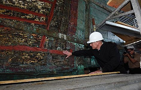 Master Chief Petty Officer of the Navy (MCPON) Steven Giordano touches the keel of USS Constitution during his visit.  The ship, nicknamed 'Old Ironsides', is the oldest commissioned ship in the Navy, and was Giordano's first visit as the 14th MCPON.  U.S. Navy photo by Mass Communication Specialist 1st Class Martin L. Carey (Released)  160908-N-OT964-354