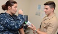Navy Hospitalman Recruit Joseph Hinson, of Naval Branch Health Clinic Jacksonville, takes vital signs of Aviation Boatswain’s Mate Airman Krista Leandry during a physical exam. One of the most important things women can do to maintain good health is schedule an annual Well Woman visit with their healthcare provider. Well Woman exams help assess individual risks for women and can provide services for immunizations, contraceptives, screening for disease and counselling for sexually transmitted infections. (U.S. Navy photo by Jacob Sippel)