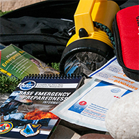emergency supplies including a flashlight and disaster preparedness book