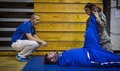 Air Force Maj. (Dr.) Sean Martin, the chief of sports medicine with Air Force Special Operations Command Office of the Surgeon General, watches as Air Force Staff Sgt. Jennifer Enderud, the NCO in charge of physical therapy with the 1st Special Operations Medical Operations Squadron, stretches an athlete’s hamstring during a Warrior Games training camp at Hurlburt Field, Florida. 
