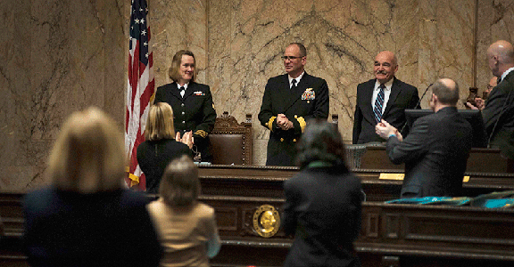 OLYMPIA, Wash. (Feb 26, 2016) - Rear Adm. Jeff Ruth, a Key West, Fla., native serving as commander, Navy Region Northwest (CNRNW), receives a standing ovation when introduced to the Washington House of Representatives during Olympia Navy Day at the Washington State Legislative Building. The visit was arranged and coordinated through CNRNW's annual visit to the Capitol Campus with commanding officers and master chiefs from tenant commands throughout the region to meet with state officials for a continuing resolution with the U.S. Navy. (U.S. Navy photo by Mass Communication Specialist 2nd Class Cory Asato/Released)