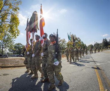 An honor guard for the 335th Signal Command (Theater) marches off the parade field at Fort McPherson, Ga., after performing in a change of command ceremony, Oct. 15, 2016. U.S. Brig. Gen. Christopher R. Kemp, outgoing commander of the 335th relinquished command to Brig. Gen. (Promotable) Peter A. Bosse at the ceremony. (U.S. Army photo by Staff Sgt. Ken Scar)