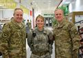 Gen. Mark Welsh III, Chief of Staff of the Air Force (left), poses for a picture with 1st Lt. Meghan Eckenrode, 379th Expeditionary Security Forces Squadron (center) and Chief Master Sgt. of the Air Force, James Cody (right), in the Blatchford-Preston Complex Dining Facility at Al Udeid Air Base, Qatar Dec. 11. Welsh and Cody met with airmen during their visit to AUAB and thanked them for their service. (U.S. Air Force photo by Tech. Sgt. James Hodgman/Released)