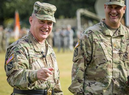 U.S. Reserve Brig. Gen. Christopher R. Kemp, outgoing commander of the 335th Signal Command (Theater), shares a laugh with some of his comrades at his change of command ceremony at Fort McPherson, Ga., Oct. 15, 2016. Kemp relinquished command of the 335th to Brig. Gen. (Promotable) Peter A. Bosse at the ceremony. (U.S. Army photo by Staff Sgt. Ken Scar)