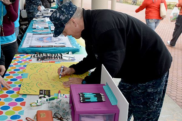 Vice Admiral Robert Thomas, commander of U.S. 7th Fleet, signs a poster during the start of Sexual Assault Awareness Prevention Month (SAAPM) at Command Fleet Activities Yokosuka, Japan. SAAPM is part of a Department of Defense wide program to eliminate sexual assault.  U.S. Navy photo by Mass Communications Specialist 2nd Class Peter Burghart (Released)  150403-N-XN177-165