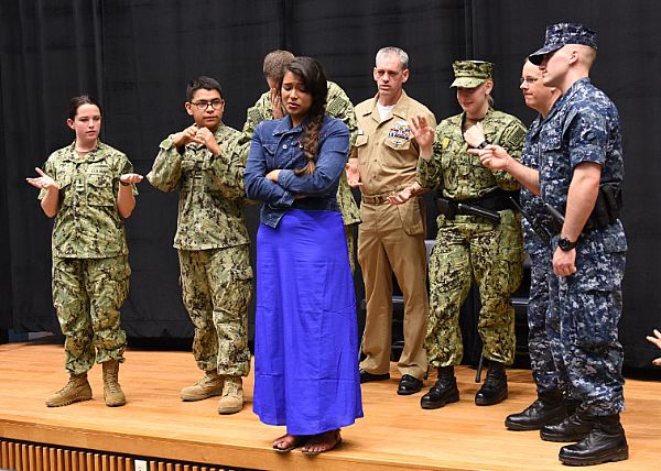 Sailors from U.S. Naval Forces, Korea participate with actor Briza Covarrubias of the acting troupe InterACT during a sexual assault prevention and response training scenario at Commander, Fleet Activities Chinhae.  U.S. Navy photo by Mass Communication Specialist 1st Class Abraham Essenmacher (Released)  150619-N-AD372-099