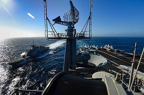The littoral combat ship USS Freedom (LCS 1) transits alongside the aircraft carrier USS John C. Stennis (CVN 74). U.S. Navy ships are underway conducting an independent deployer certification exercise in the Southern California operating area. The exercise provides a multi-ship environment to train and certify independent deployers in surface warfare, air defense, maritime interception operations, command and control/information warfare, command, control, computers and combat systems intelligence and mine warfare.  U.S. Navy photo by Mass Communication Specialist Seaman Christopher Frost (Released)  150427-N-IK337-212