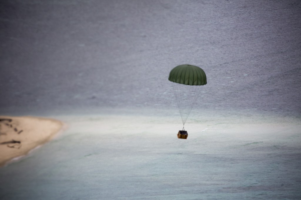 A low-cost, low-altitude bundle of donated goods drops to Ngulu island, Federated States of Micronesia, Dec. 11, 2015, during Operation Christmas Drop. Operation Christmas Drop allows the 374th Airlift Wing and international partners from the Japan Air Self-Defense Force and Royal Australian Air Force to practice dynamic delivery airdrop with unsurveyed drop zones while providing critical supplies to 20,000 islanders. (U.S. Air Force photo by Osakabe Yasuo/Released)