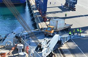 A trailer operator for Medcenter Container Terminal transfers a container from the M/V Ark Futura, a Danish cargo ship, along the dock to the loading deck of M/V Cape Ray during operations at the Italian port of Gioia Tauro, July 2, 2014. The Cape Ray is tasked with the neutralization of specific chemical materials from Syria in accordance with the Organization for the Prohibition of Chemical Weapons guidelines while operating in international waters. U.S. Navy photo by Seaman Desmond Parks