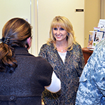 Woman greeting a service member and his spouse