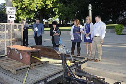 Defense Logistics Agency employees view a piece of the steel beams salvaged from the debris of the World Trade Center on display at the Patriot Day event conducted at the Hart-Dole-Inouye Federal Center in Battle Creek, Michigan. 