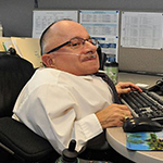 Physically impaired businessman working at a computer