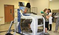 A physical therapy assistant demonstrates how the Anti-gravity Treadmill is used during an open house at Martin Army Community Hospital's Physical Therapy Clinic. (U.S. Army photo by Reginald Rogers) 