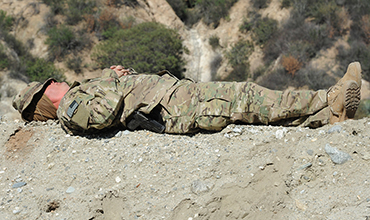 Photo: Soldier sleeping on the ground.